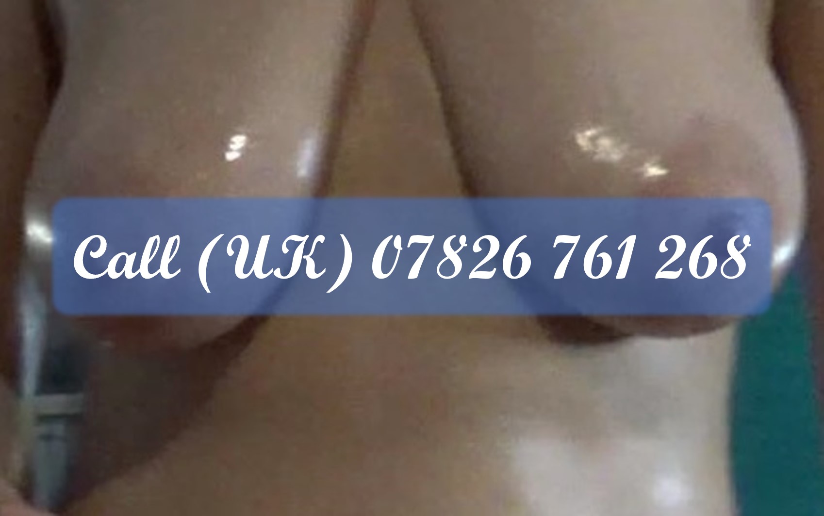 A picture of my oily breasts with nipples obscured by my phone number