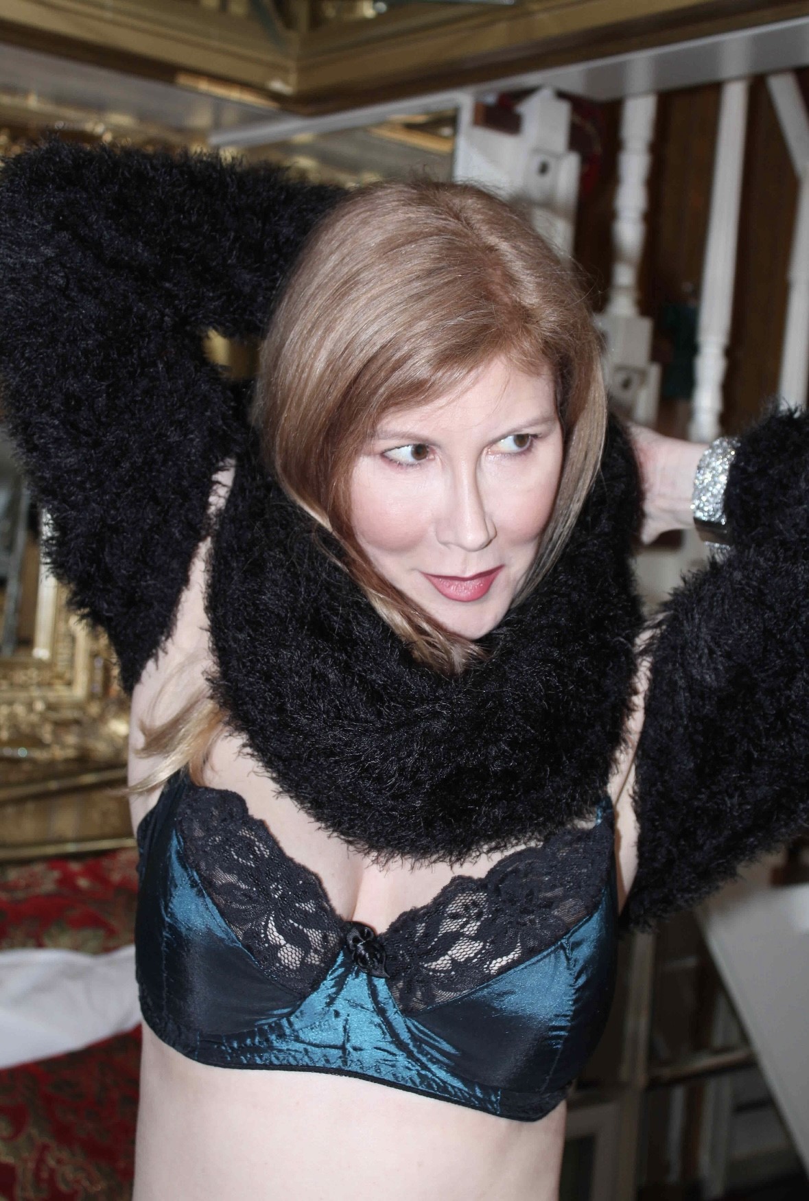 Francesca wearing a dark lacy bra and a black faux fur stole
